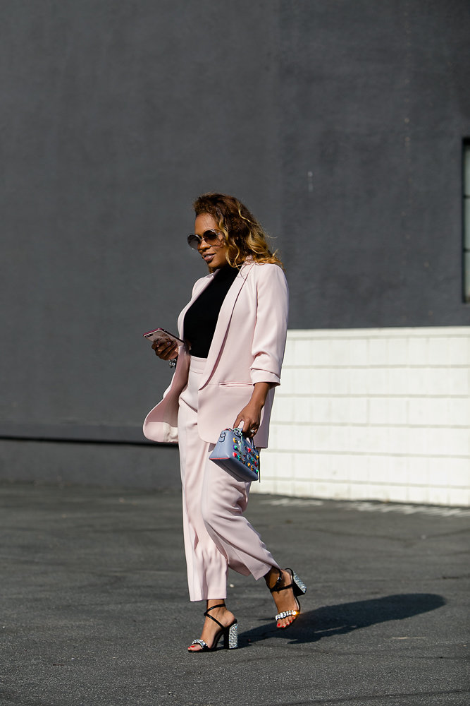 Hautemommie wears pink suit and carries phone covered in Kate Spade
